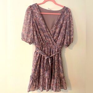 Light purple floral a-line short dress with tie detail & wrap style.